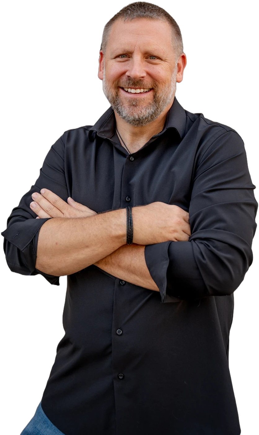 Charlie Whitaker, arms crossed, smiling